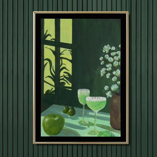Framed artwork of two green cocktails and an apple and pears on a table with a window in the background. Also a brown earthen vase with white flowers