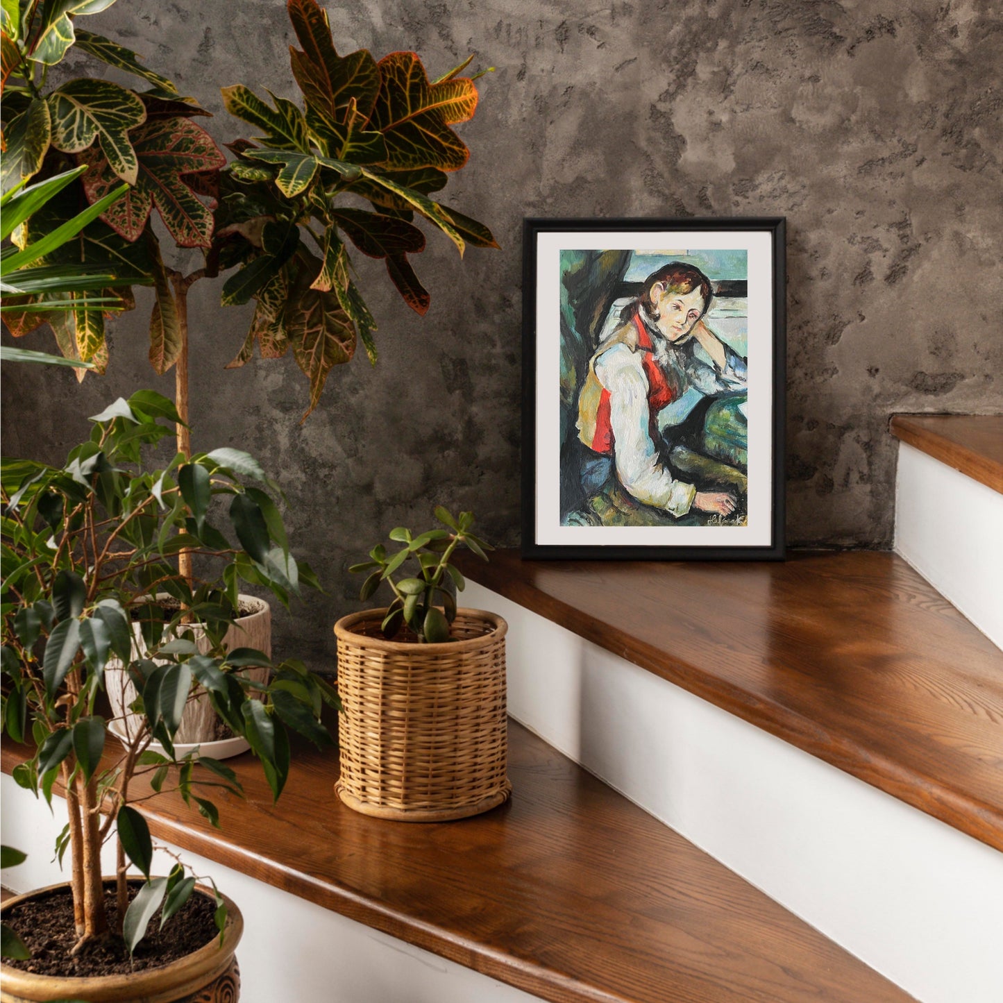 Framed artwork on a wooden step with plants