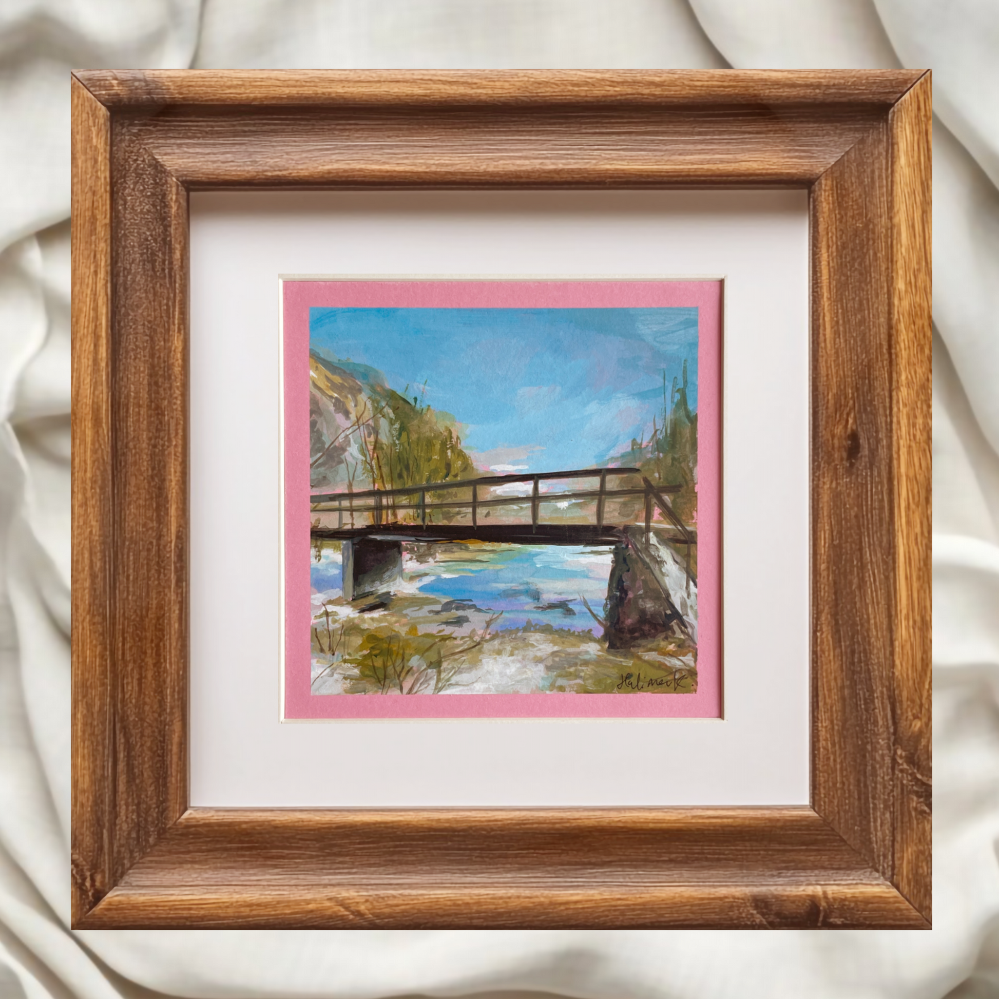 Painting of a bridge and stream near Lake Bohinj. Brown wooden frame, fabric backgorund. artist halima khanum. 