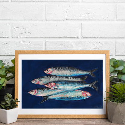 Framed original painting of food art - fish on a blue background against a white brick wall.