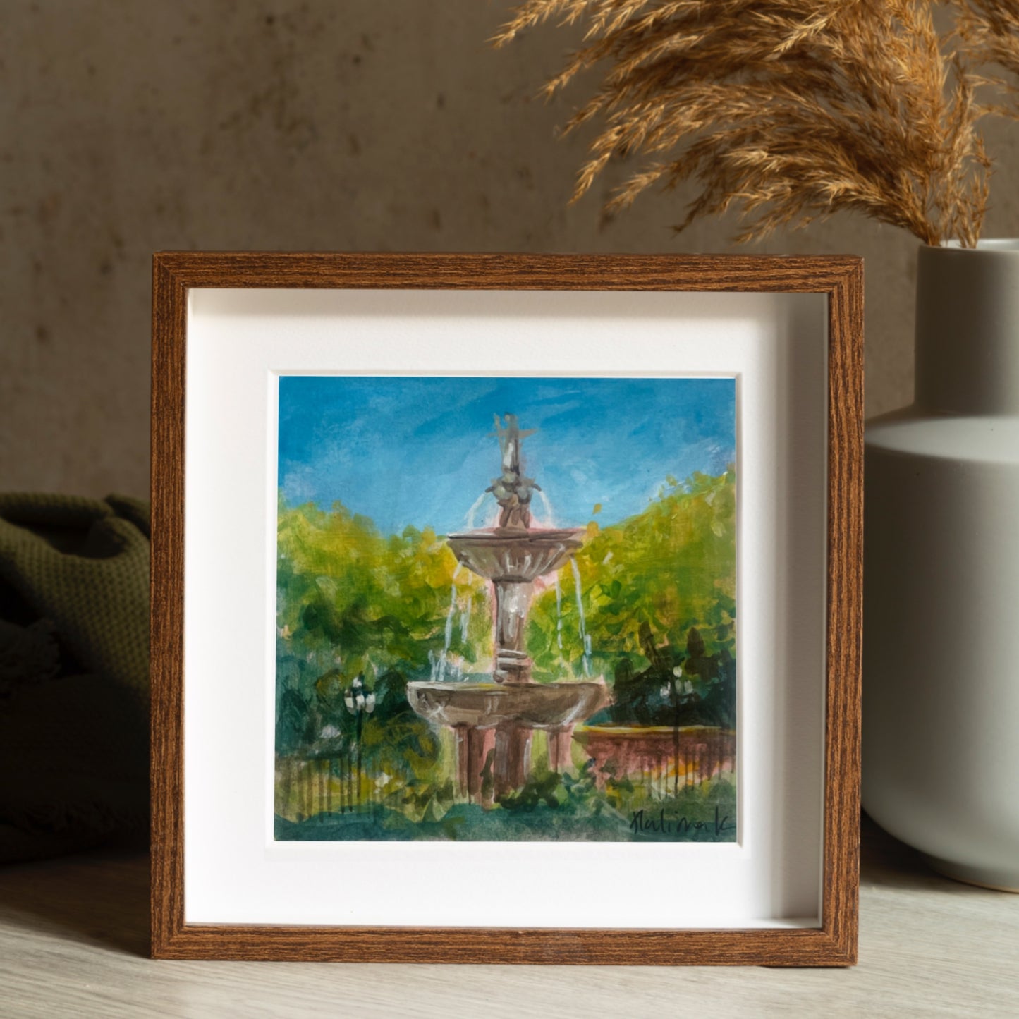 dark wood framed painting of a fountain in spain