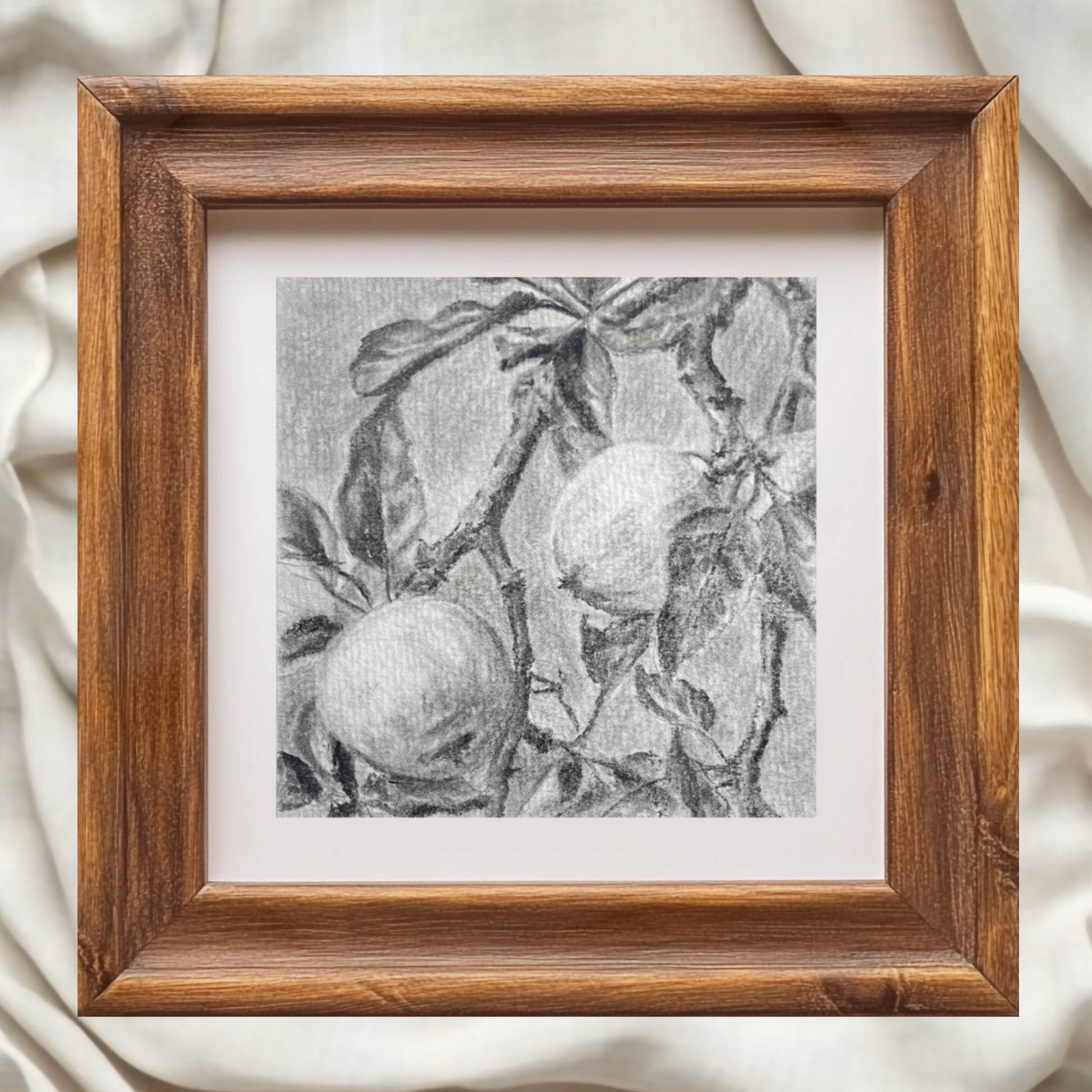wood framed black and white artwork of fruit on a branch against a white background