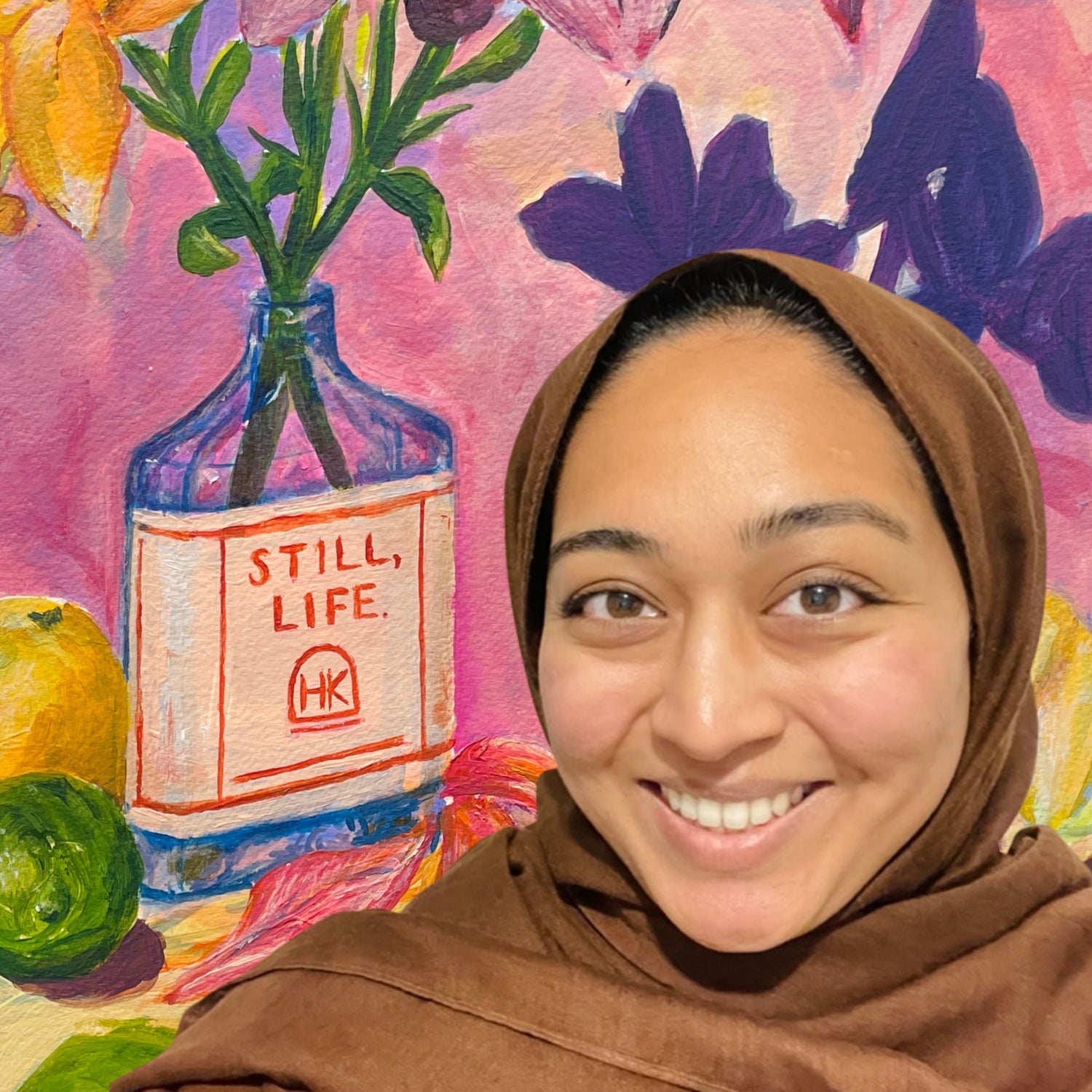 Woman wearing a brown hijab in front of a colorful, modern still lift painting with a glass bottle flower vase, lemons and limes