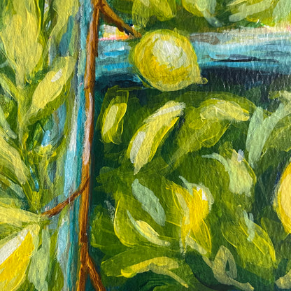 close up of a single lemon against many green leaves and the rung of a blue ladder 