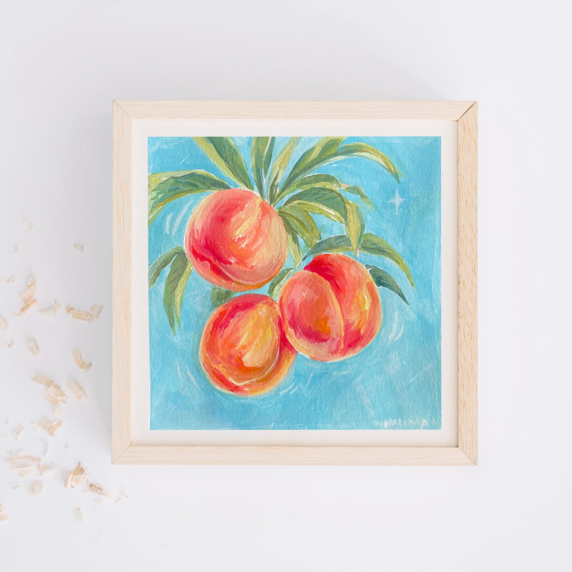 Framed artwork of halima khanum's early work of peaches on a blue background