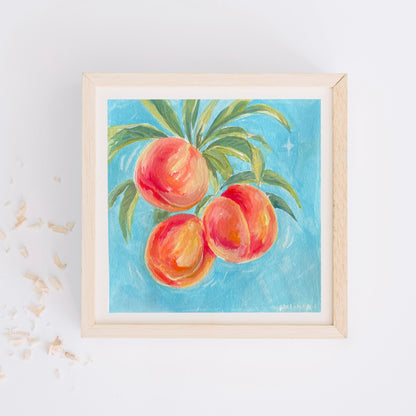 Framed artwork of halima khanum's early work of peaches on a blue background