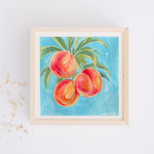 Framed artwork of halima khanum's early work of peaches on a blue background