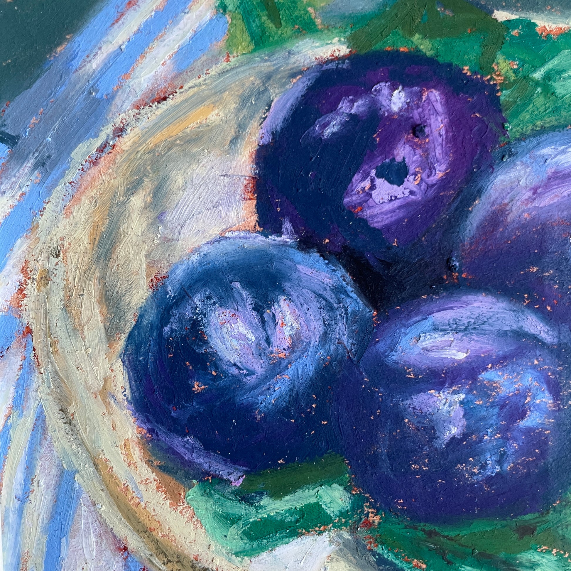 Artistic depiction of plums o a plate on top of leaves and stripy cloth