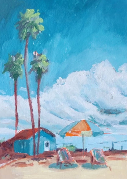 An impressionistic painting of a beach scene with tall palm trees, a small blue house with a red roof, a blue and orange beach umbrella, and lounge chairs under a bright blue sky with white clouds.