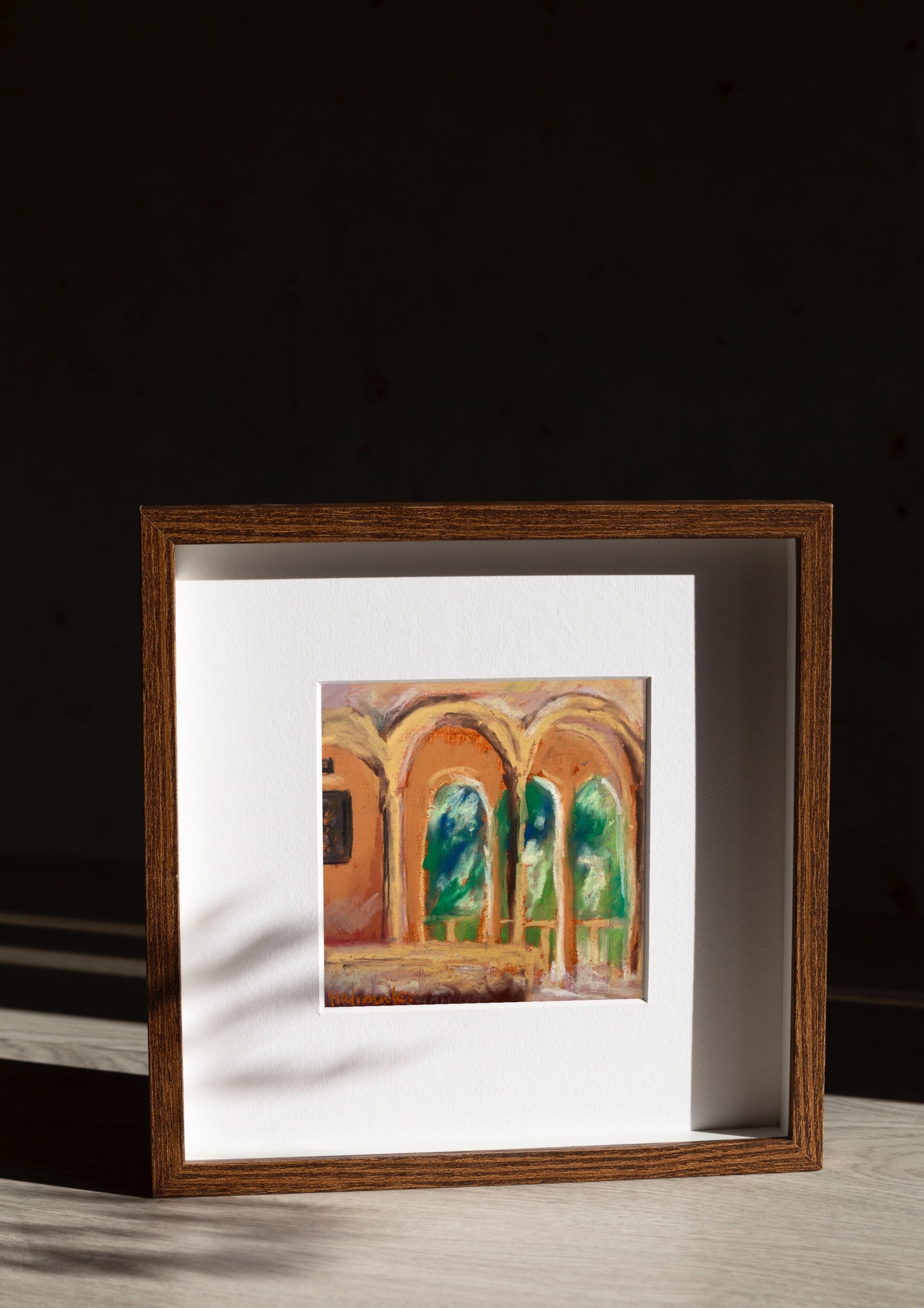 framed mini square oil pastel painting of euro summer under arches against a dark background