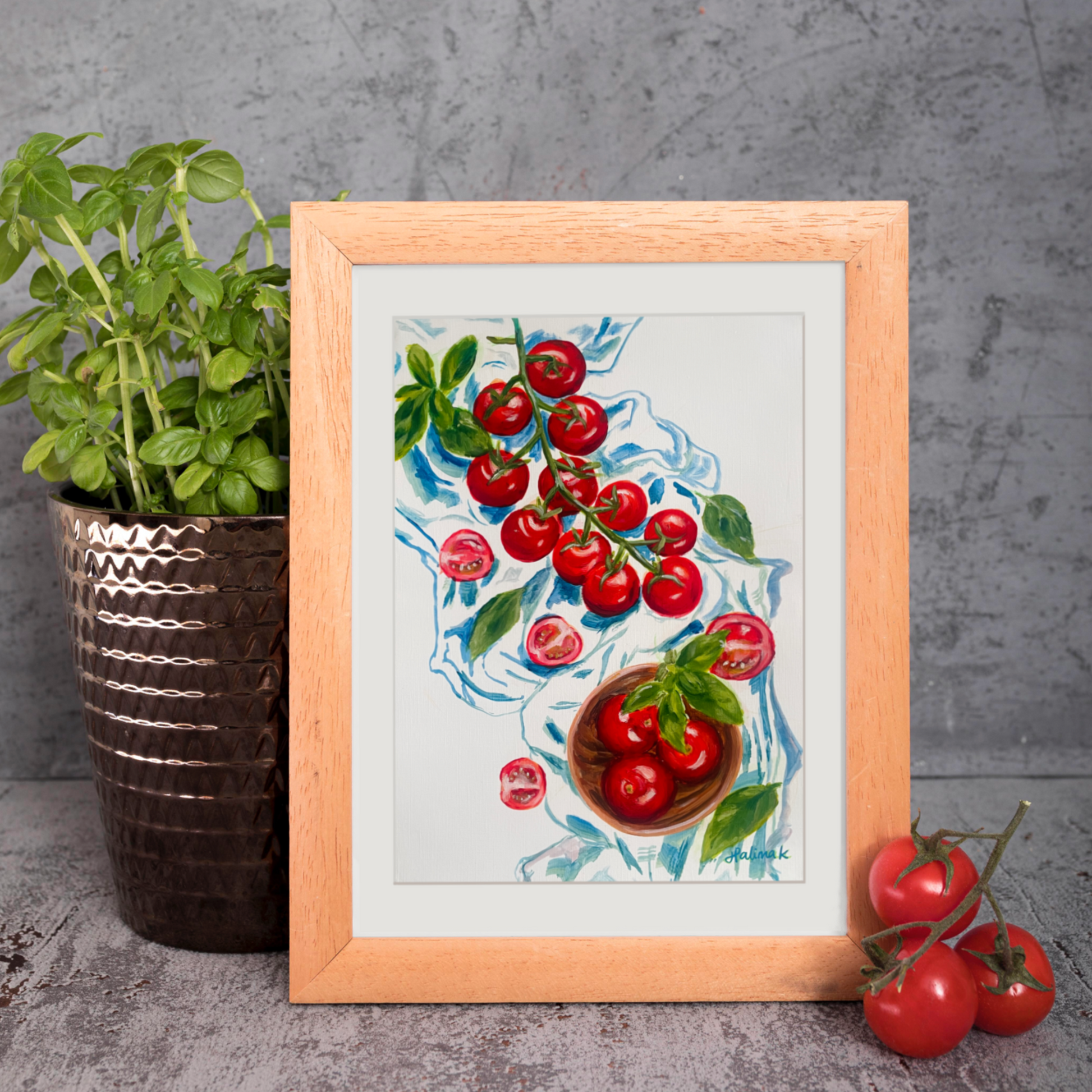 Light wood framed painting of tomatoes on the vine with a blu ecloth. three tomatoes in foreground and basil plant in background. 