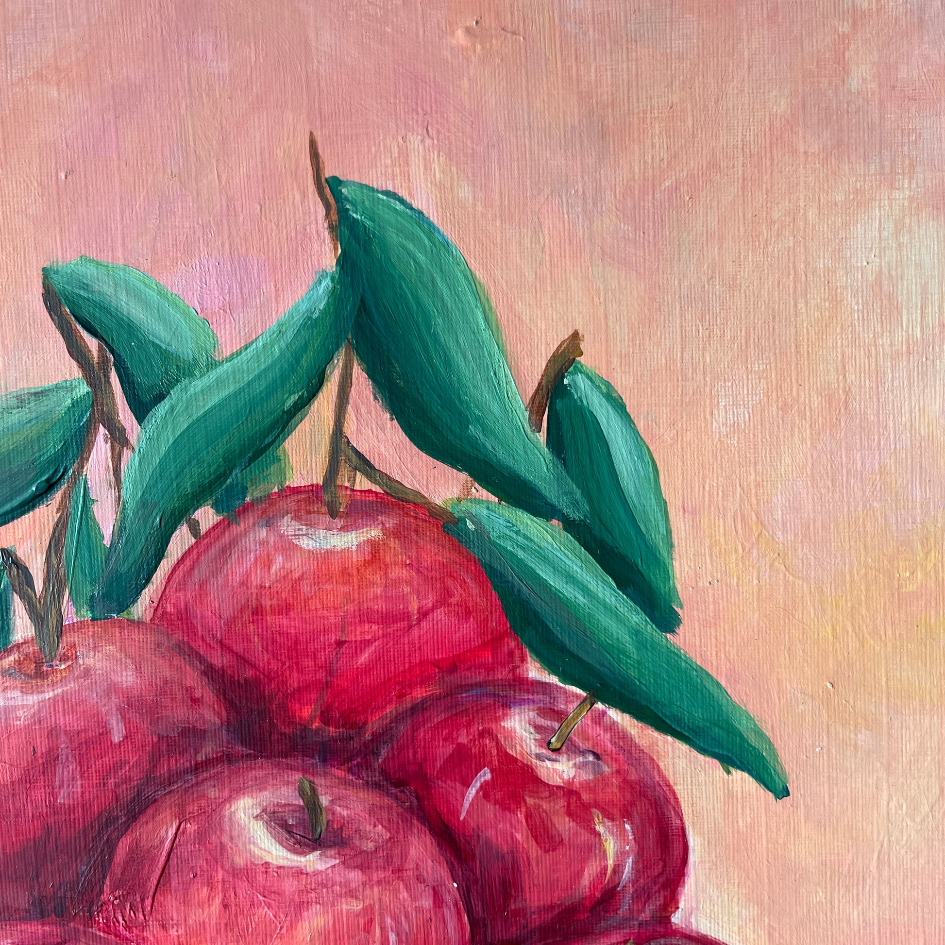 Painting of red apples with green leaves on a textured beige background