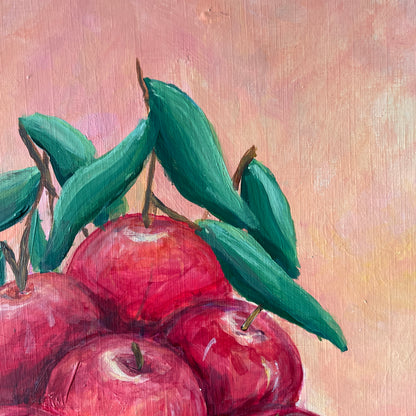 Painting of red apples with green leaves on a textured beige background