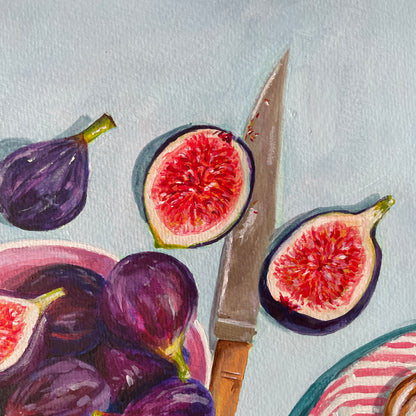 close up of knife with figs bits on and sliced fruit nearby