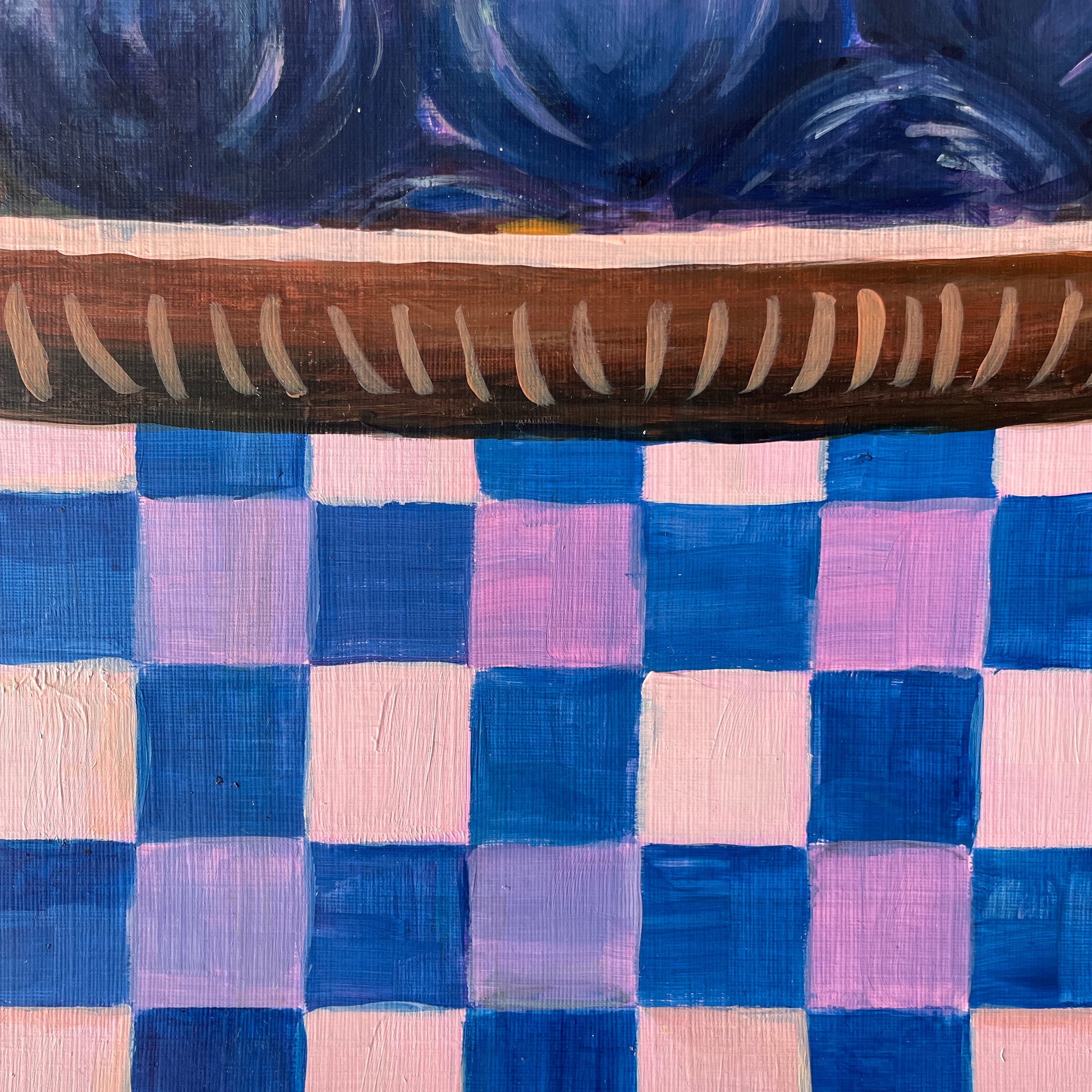 Wooden dish on a checkered fabric background with blue and pink squares