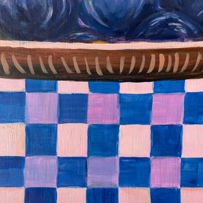 Wooden dish on a checkered fabric background with blue and pink squares
