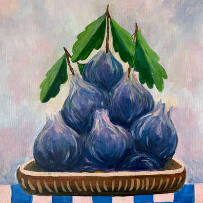 Painting of blue figs on a wooden plate with green leaves against a light background
